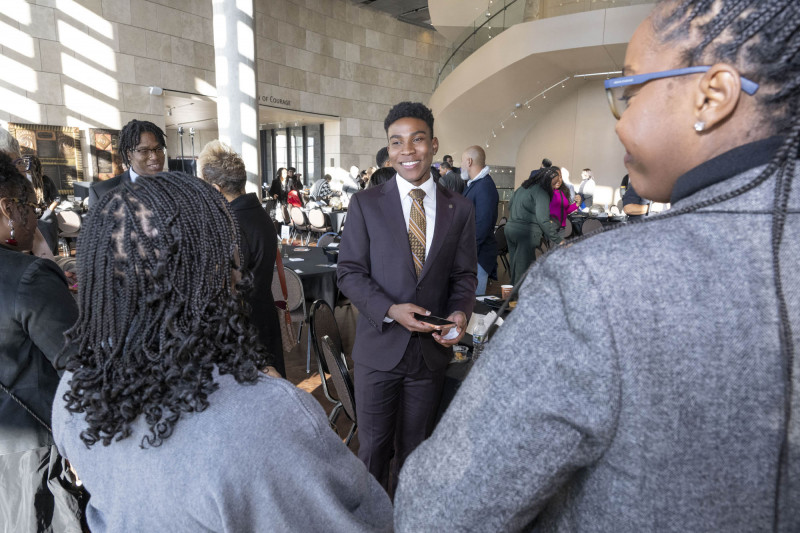 Kahlil Greene, middle talk with people after he spoke during the  MLK Day breakfast at the National Underground Railroad Freedom Center Monday January 19, 2026. Photos by Joseph Fuqua II