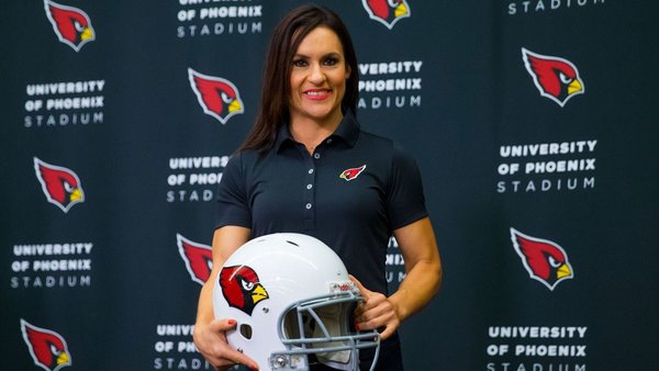 Jen Welter poses in front of a Cardinals backdrop
