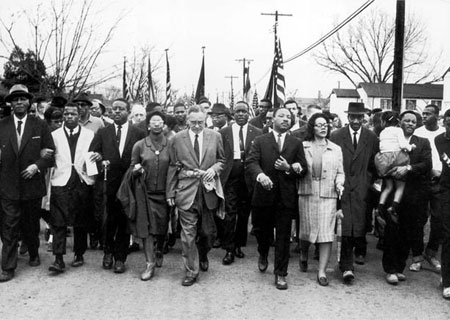 Dr. Martin Luther King, Jr. and civil rights activists leading thousands of nonviolent marchers on a 54-mile march from Selma to Montgomery
